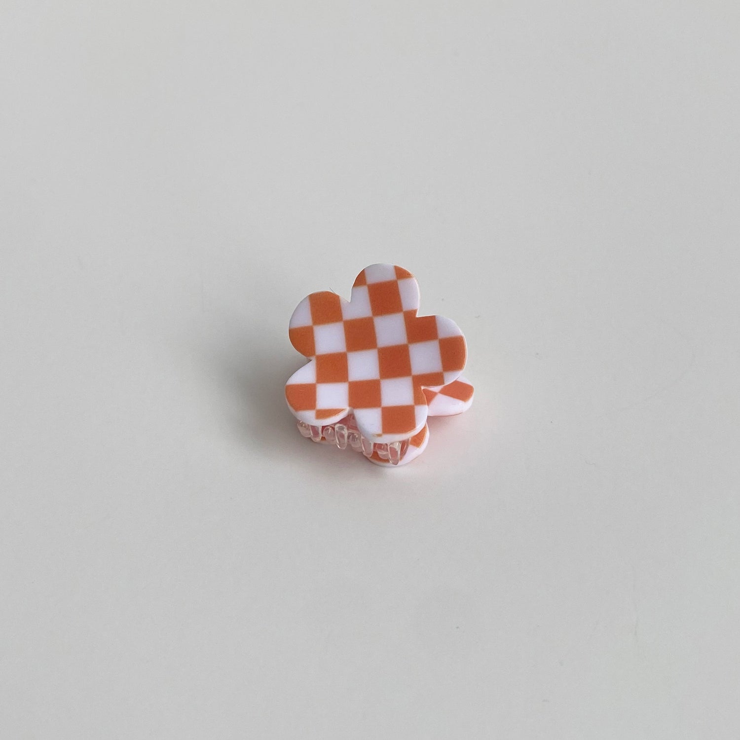 Checkered hair clip in orange checkered flower