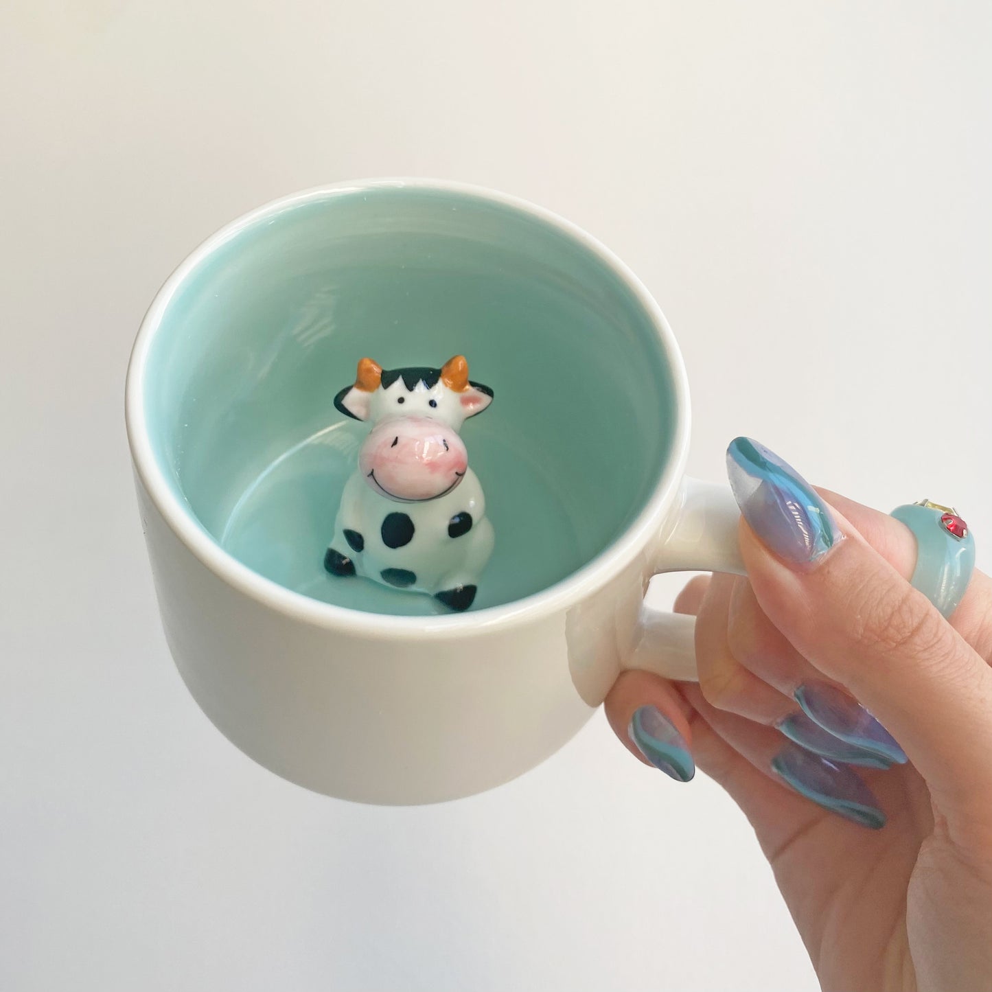 ceramic mug with cow figurine