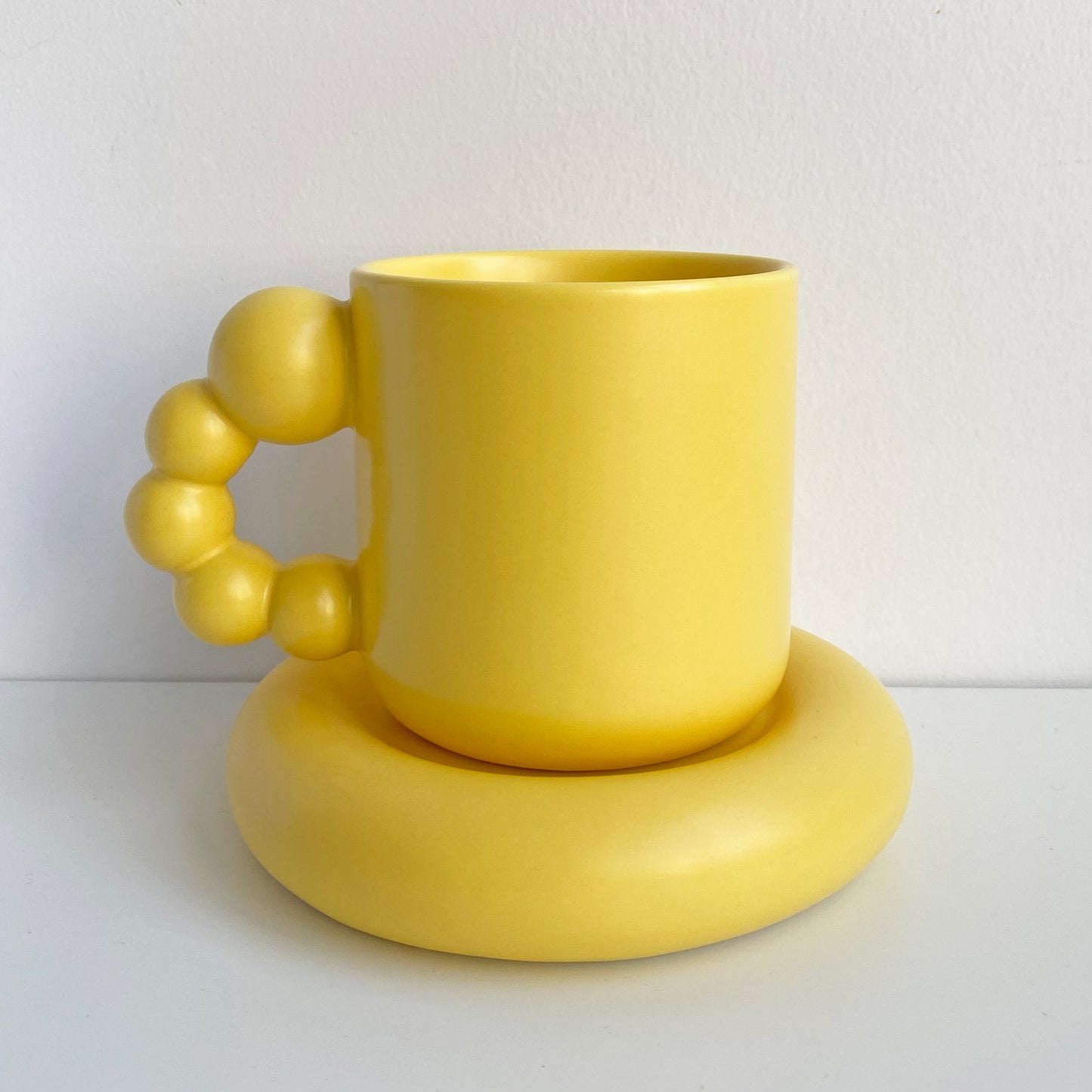 pearl handle ceramic mug in yellow