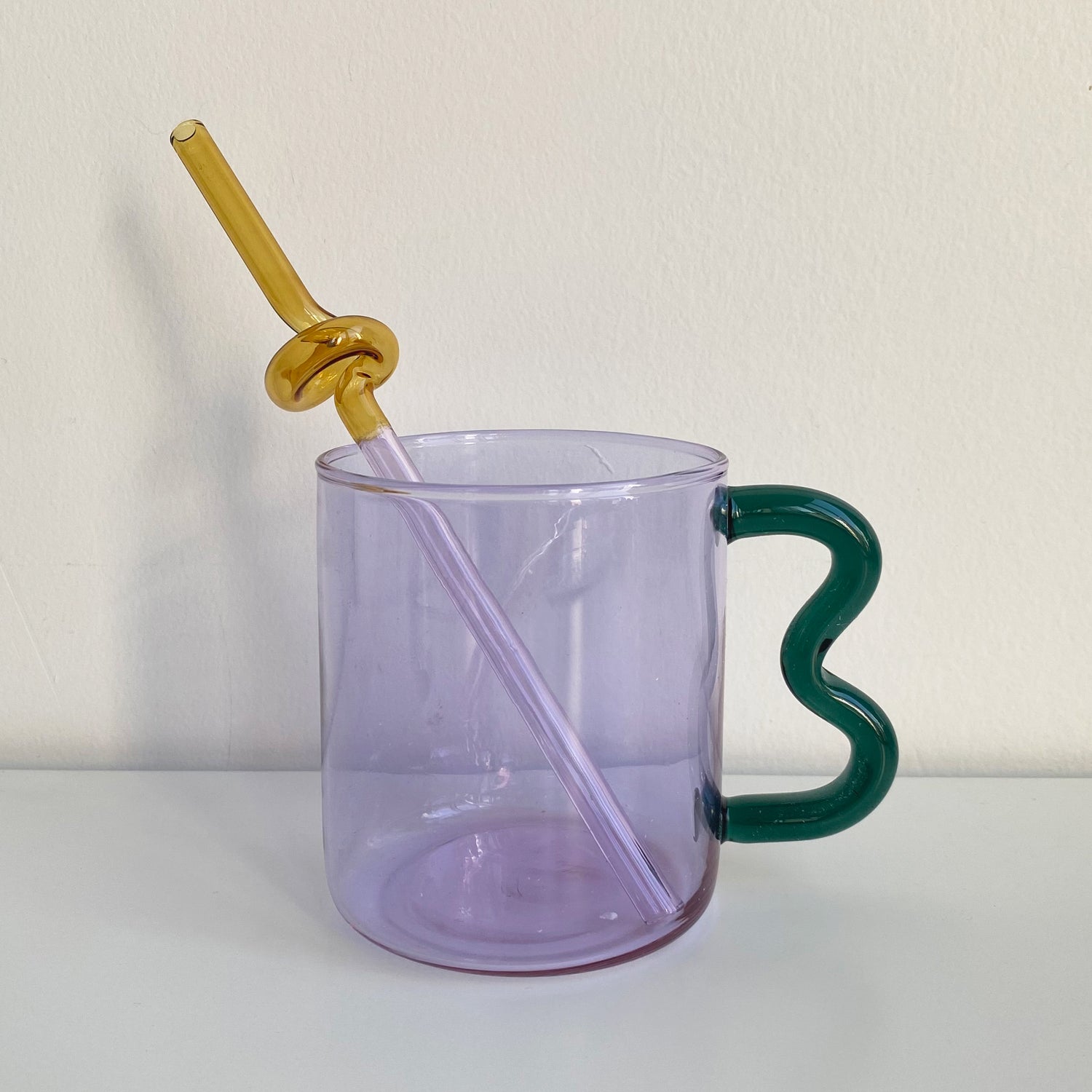wave handle glass mug in purple with blue handle