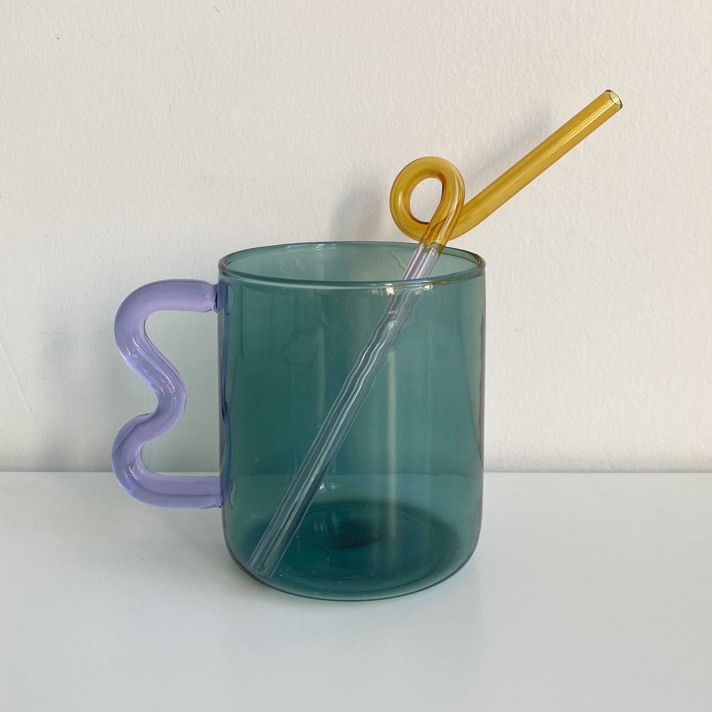 wave handle glass mug in blue with purple handle